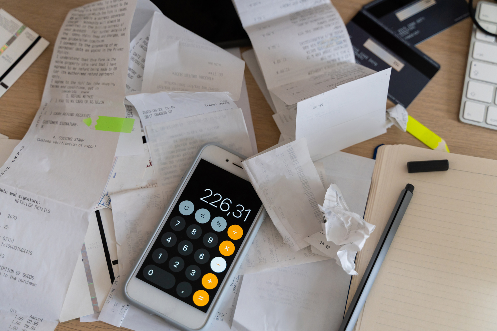 Image of a calculator amid purchase receipts