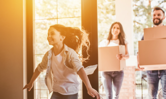 A couple move into their new home as their daughter excitedly enters the front door