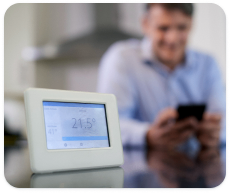 A home thermostat sits on a kitchen counter