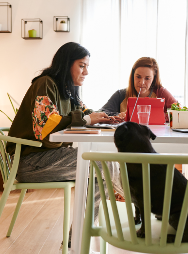 A couple sit at their dining room table to plan for their mortgage refinancing