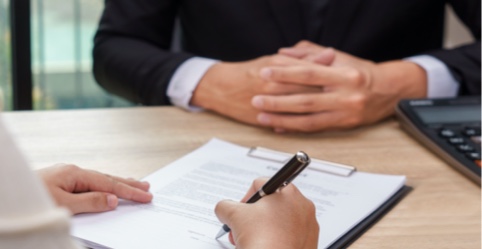 Man signing foreclosure document with lender.